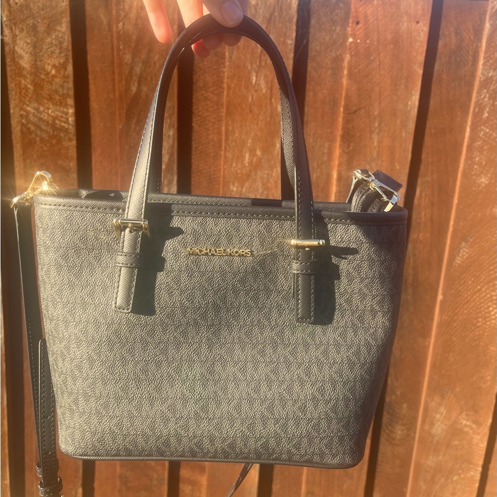 This is a small black Michael Kors tote bag, in great condition and barely used!